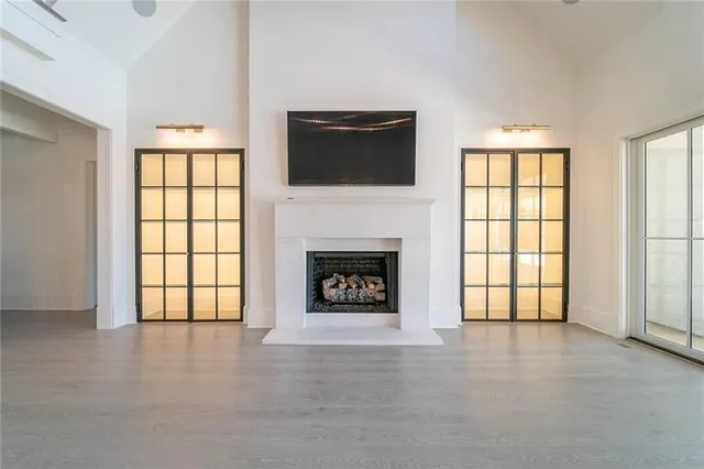 a view of an empty room with a fireplace and a window