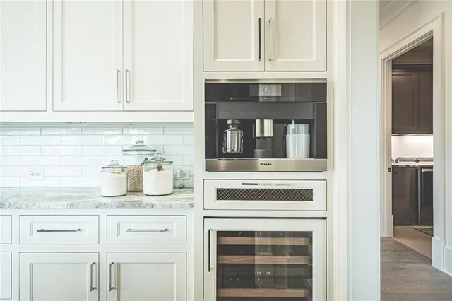 a kitchen with granite countertop white cabinets and white appliances