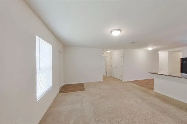 an empty room with a empty space and windows