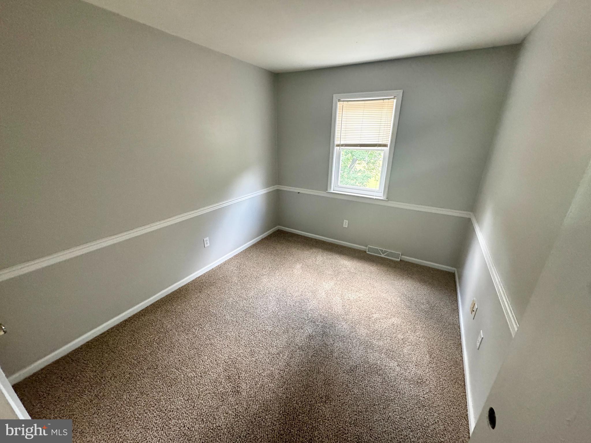 8 Forest Creek Drive Dover, DE 19904 - Photo 4 of 8 an empty room with a window