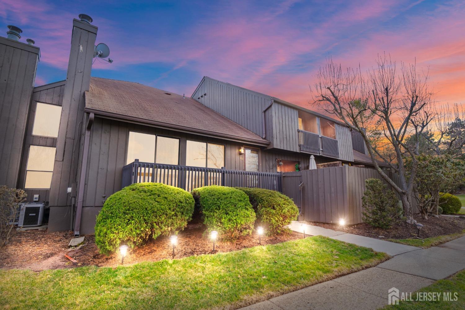 a view of backyard with plants and large tree