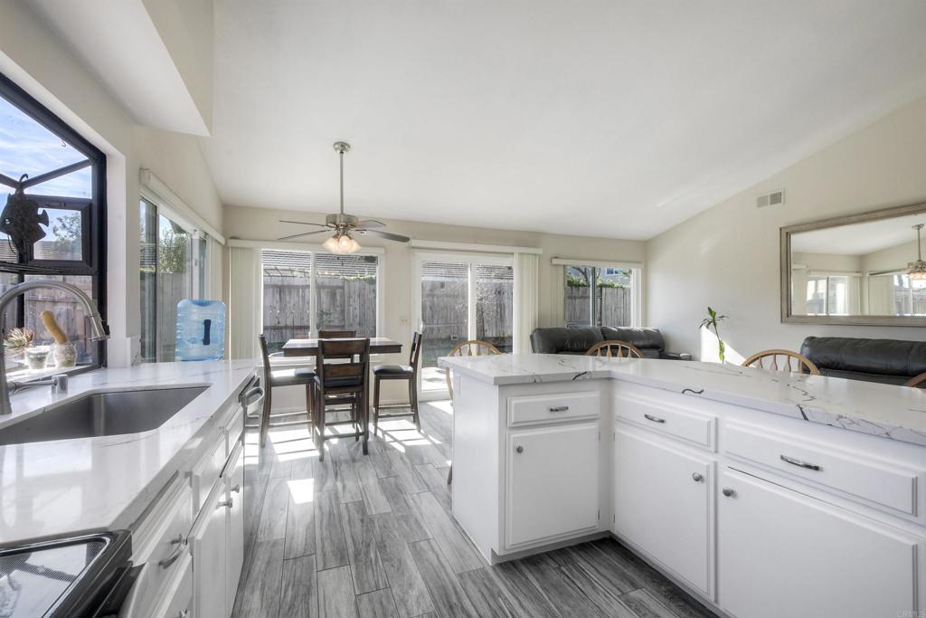 4413 Point Degada Oceanside, CA 92058 - Photo 43 of 46 a kitchen with granite countertop lots of counter space dining table and chairs