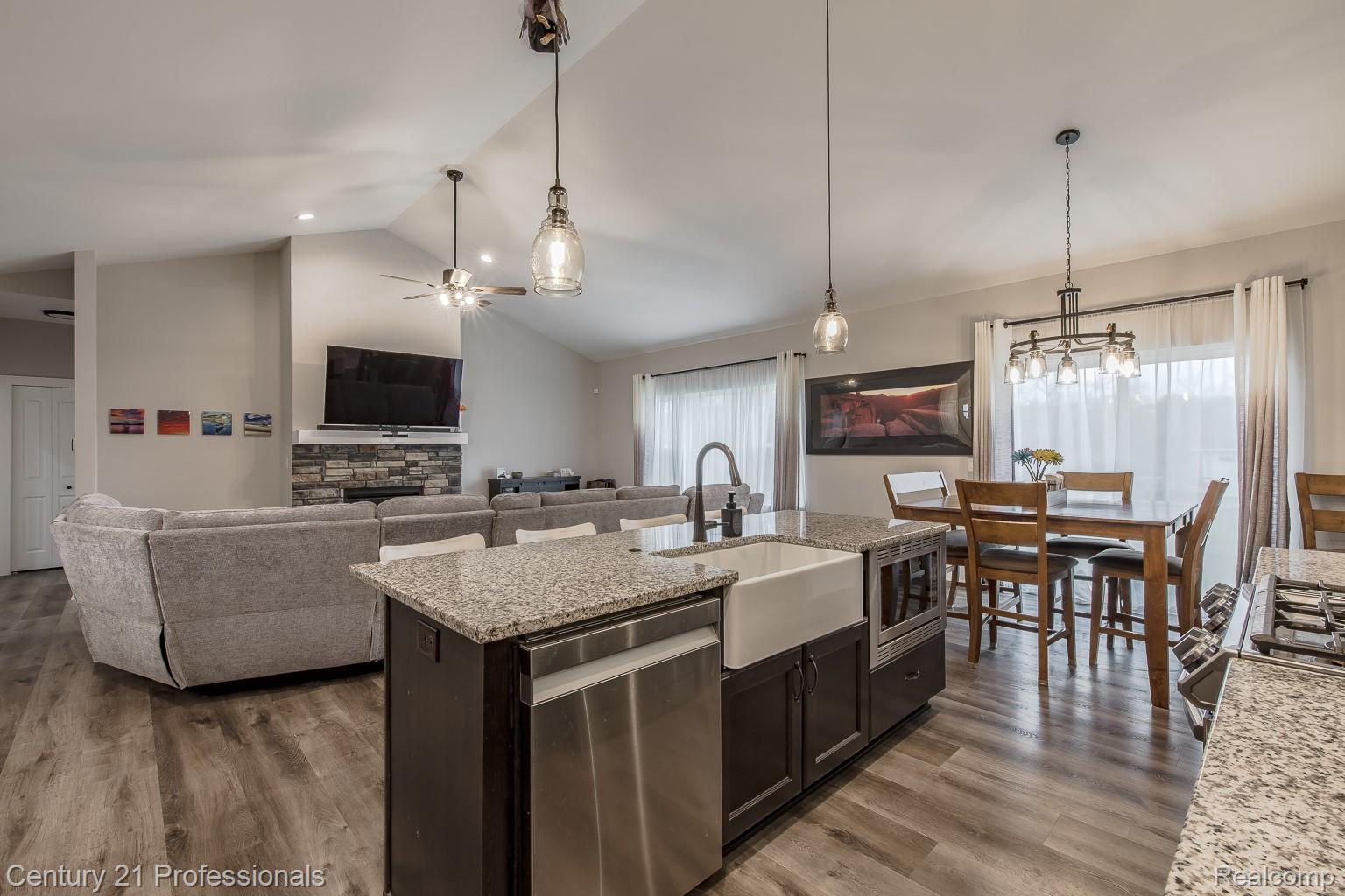 4914 TORATOLA Lane Howell, MI 48843 - Photo 38 of 39 Kitchen featuring open floor plan, stainless steel appliances, light stone countertops, dark wood-style flooring, and hanging light fixtures