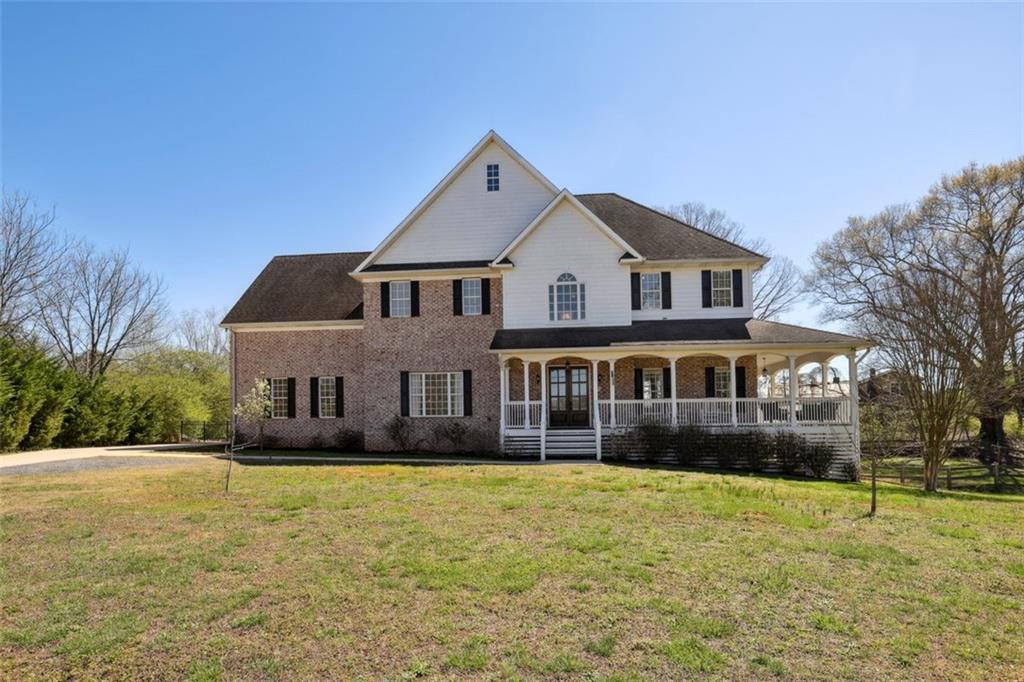 6140 Bannister Road Cumming, GA 30028 - Photo 1 of 1 a front view of a house with a yard