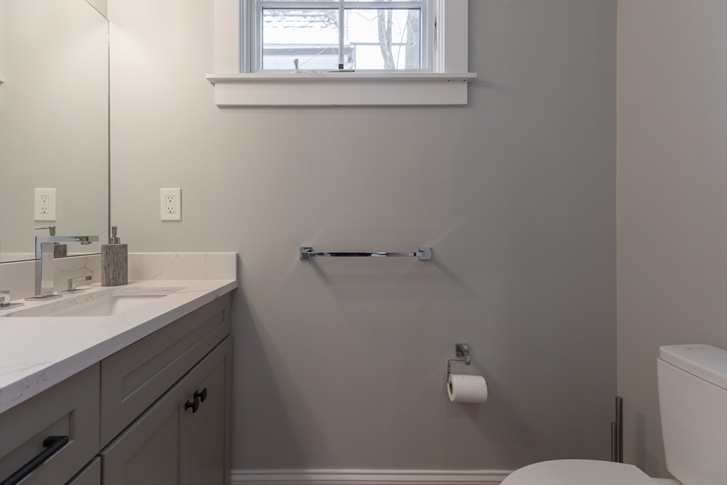 260 Amory Street Boston, MA 02130 - Photo 17 of 20 a bathroom with a sink vanity mirror and toilet