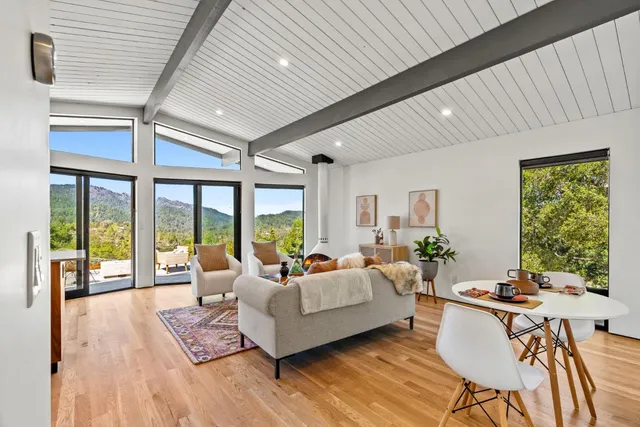 a living room with furniture and large windows