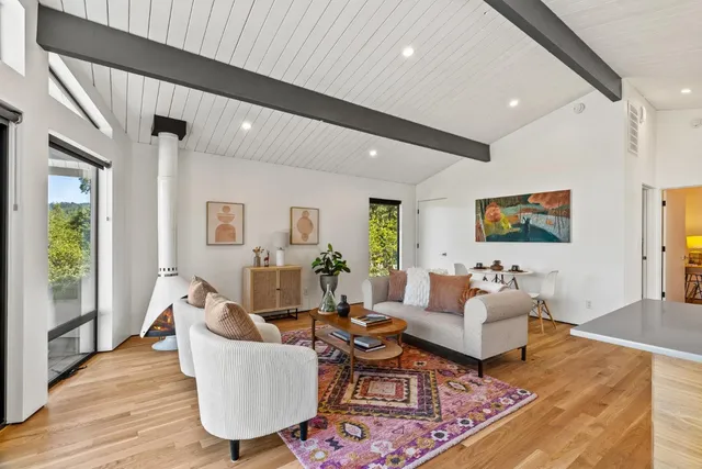 a living room with fireplace furniture and a flat screen tv