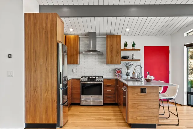 a kitchen with stainless steel appliances granite countertop a stove and a refrigerator