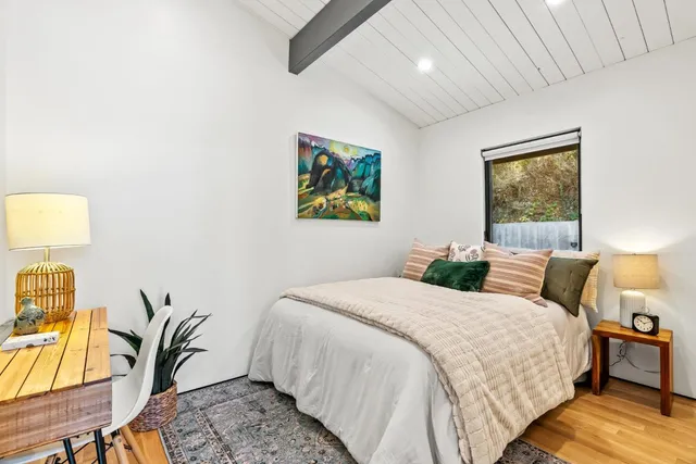 a bedroom with bed and window