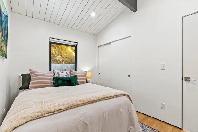 a bedroom with a bed and a window