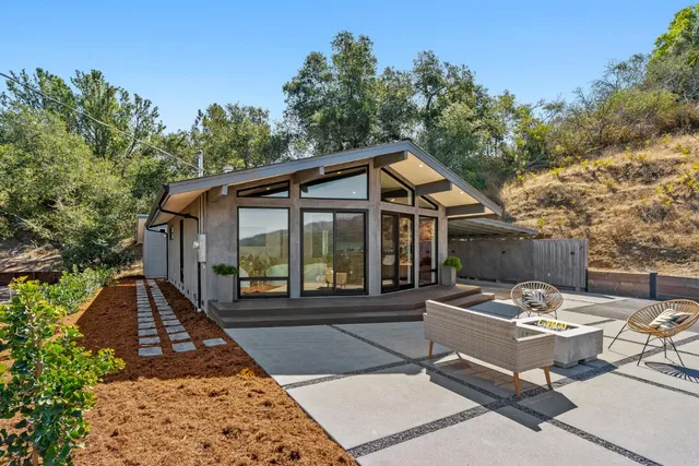a view of a house with backyard sitting area