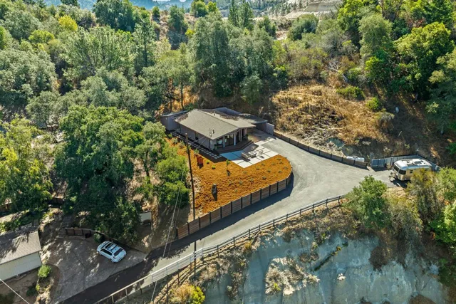 an aerial view of a house with a yard