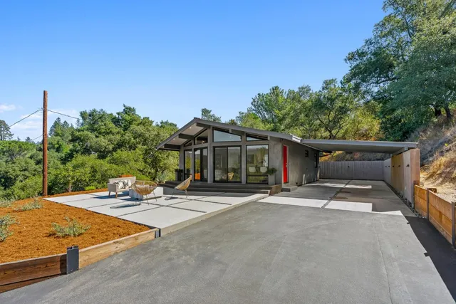 a view of a patio with table and chairs a barbeque with wooden fence