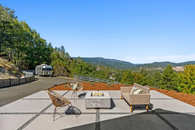 a terrace with outdoor seating and trees