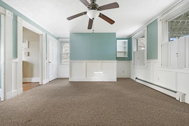 a view of empty room with ceiling fan