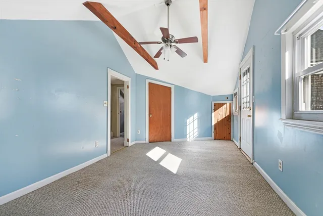 a view of a hallway with wooden floor and entryway