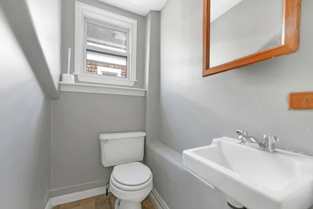 a white toilet sitting next to a bathroom sink