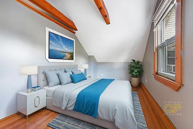 a bedroom with a bed lamp and a window