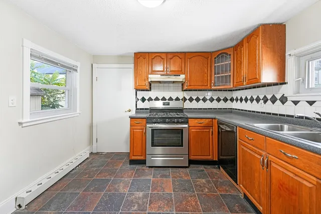 a kitchen with stainless steel appliances a stove sink and cabinets