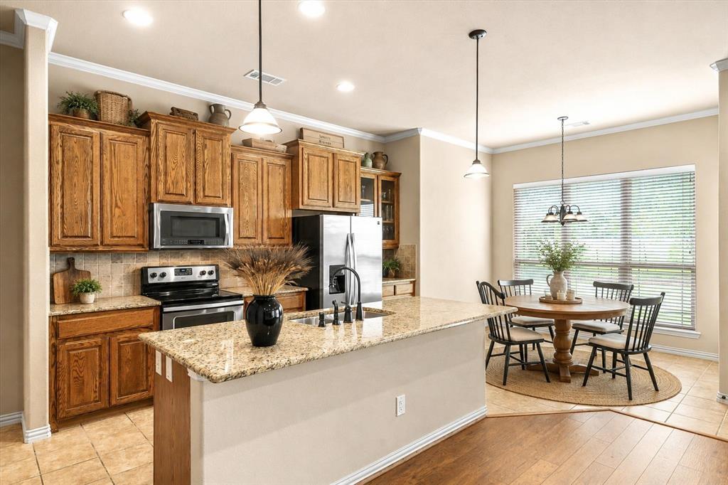 1852 Meadowview Canton, TX 75103 - Photo 9 of 28 a kitchen with stainless steel appliances kitchen island granite countertop a sink and cabinets