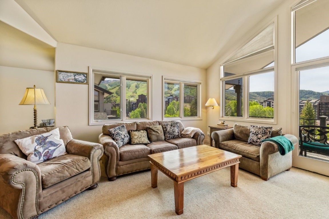 1724 Ski Time Square Drive, Unit R5 Steamboat Springs, CO 80487 - Photo 1 of 19 Living area with vaulted ceiling and carpet