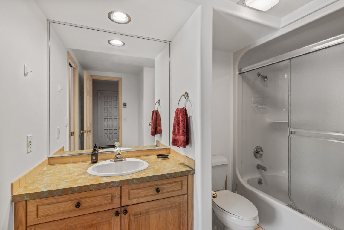 1724 Ski Time Square Drive, Unit R5 Steamboat Springs, CO 80487 - Photo 12 of 19 Bathroom featuring vanity, toilet, bathing tub / shower combination, and recessed lighting