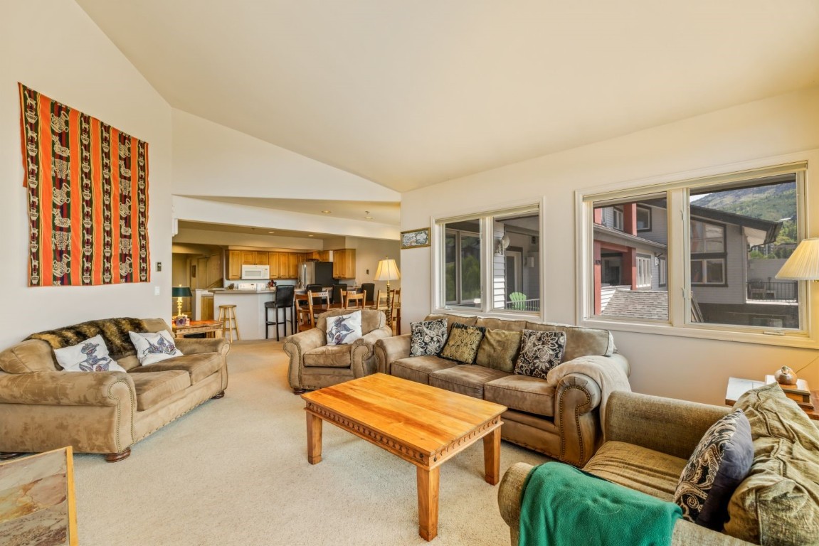 1724 Ski Time Square Drive, Unit R5 Steamboat Springs, CO 80487 - Photo 4 of 19 Living room featuring light colored carpet and high vaulted ceiling