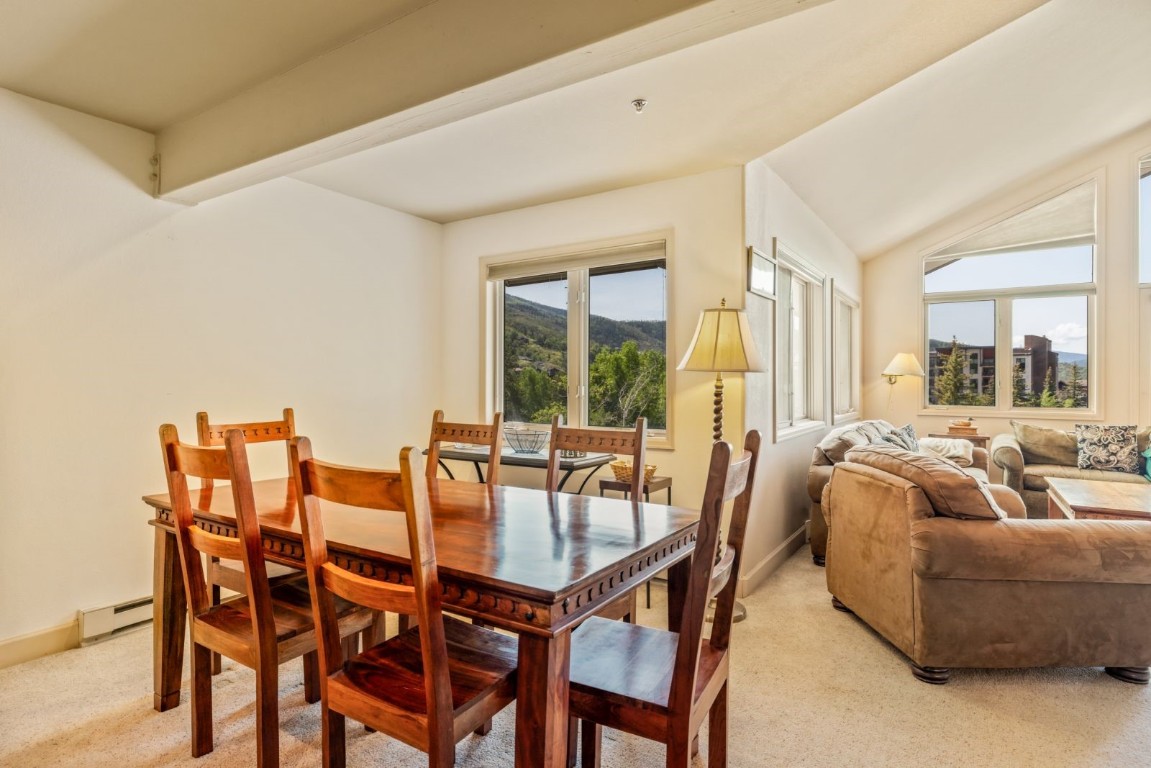 1724 Ski Time Square Drive, Unit R5 Steamboat Springs, CO 80487 - Photo 5 of 19 Dining area featuring a baseboard radiator, light colored carpet, baseboards, and lofted ceiling