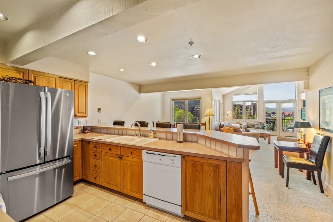 1724 Ski Time Square Drive, Unit R5 Steamboat Springs, CO 80487 - Photo 7 of 19 Kitchen featuring freestanding refrigerator, dishwasher, a sink, a peninsula, and recessed lighting