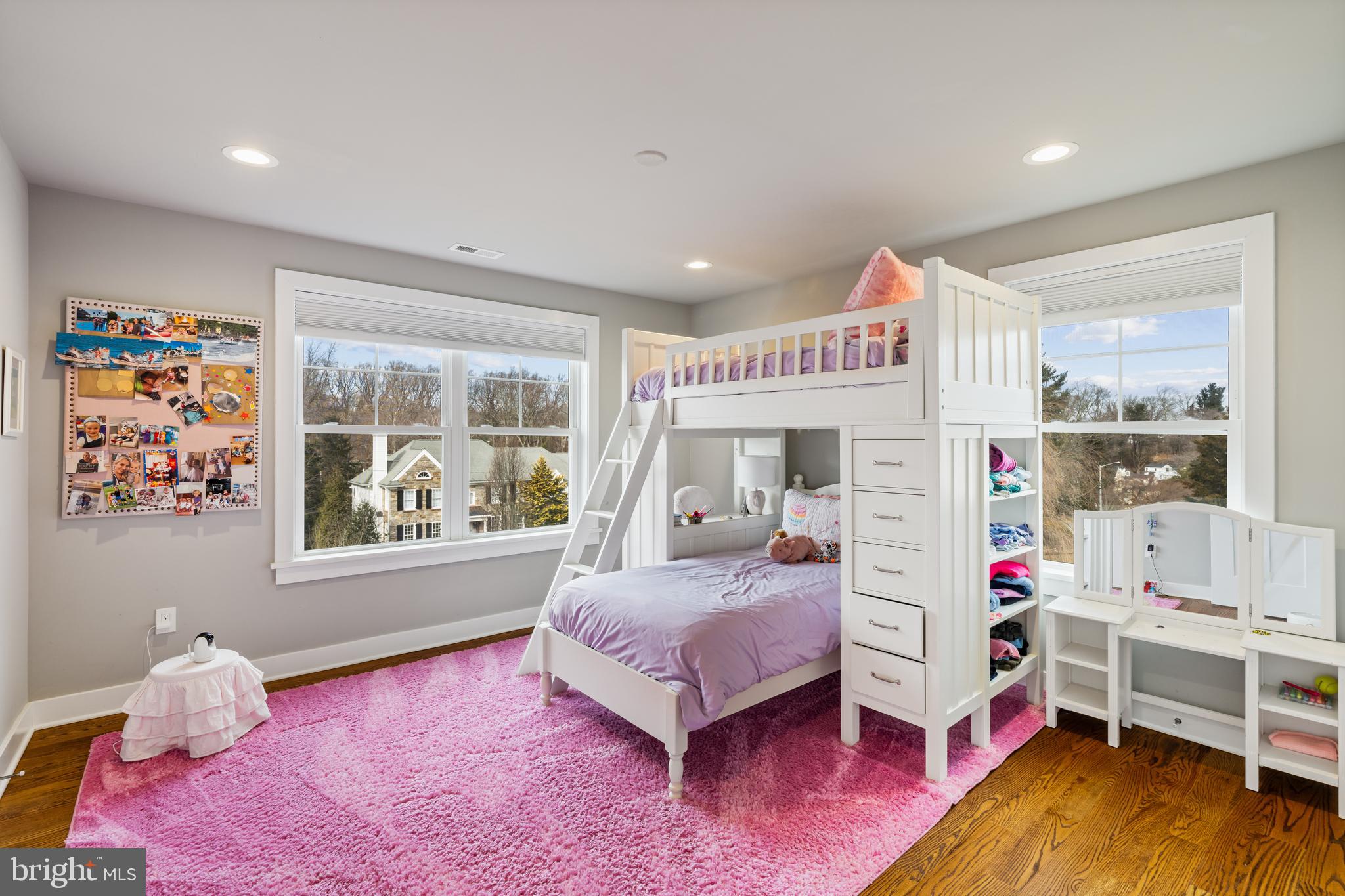 601 Spruce Lane Villanova, PA 19085 - Photo 14 of 27 a living room with furniture and a baby crib next to a window