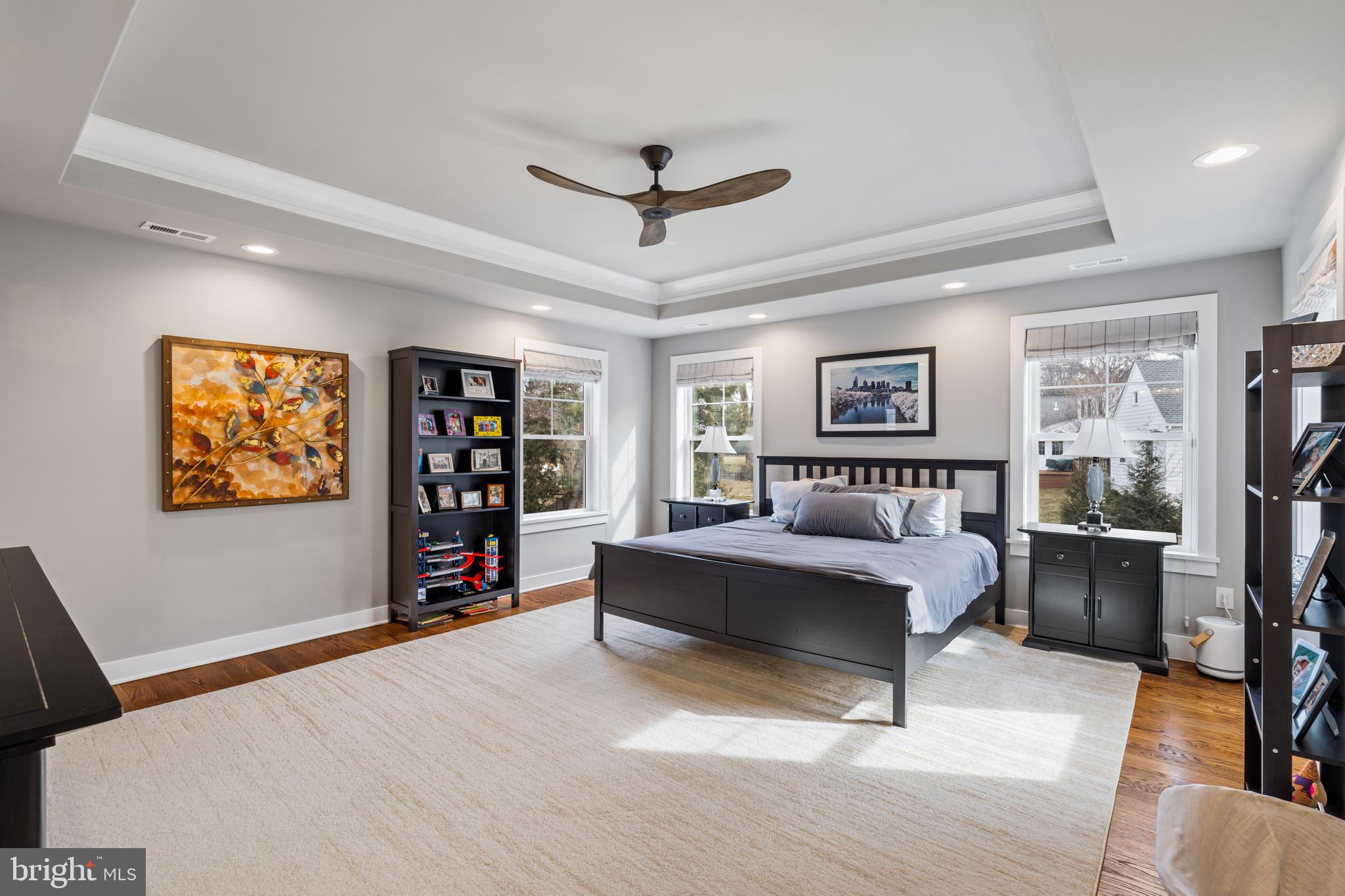 601 Spruce Lane Villanova, PA 19085 - Photo 19 of 27 a spacious bedroom with a bed a dresser and a bookshelf