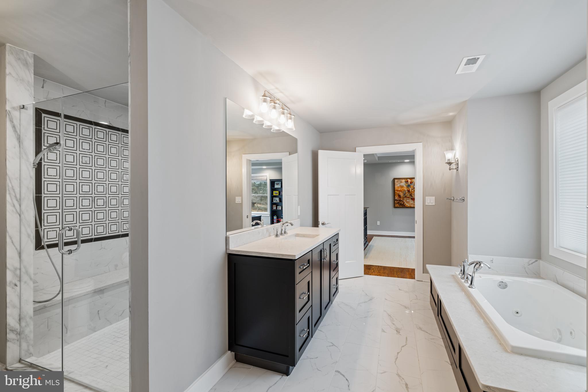 601 Spruce Lane Villanova, PA 19085 - Photo 21 of 27 a large bathroom with a tub sink shower and mirror
