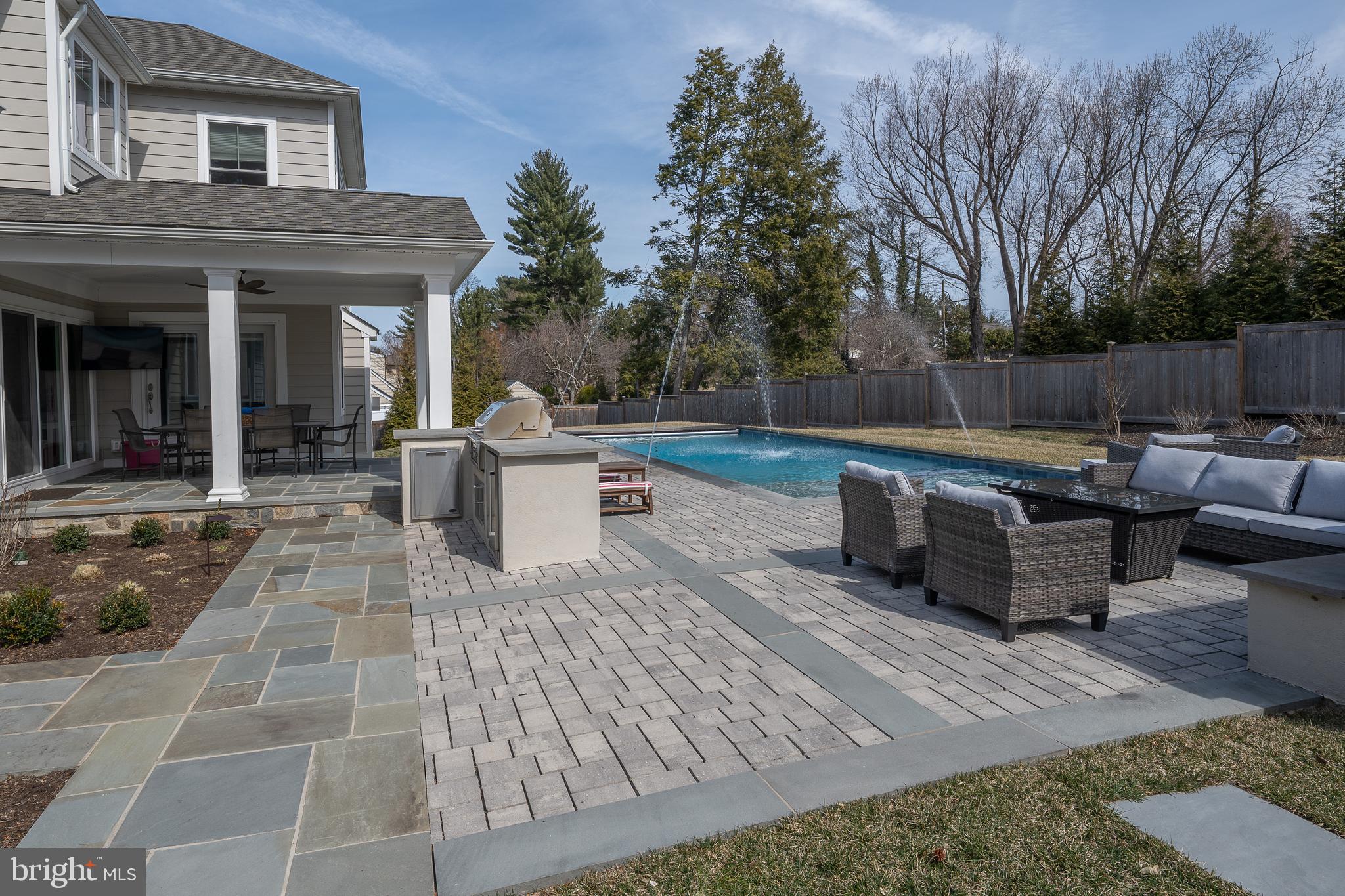601 Spruce Lane Villanova, PA 19085 - Photo 26 of 27 a view of a patio with dining table and chairs with wooden floor and fence