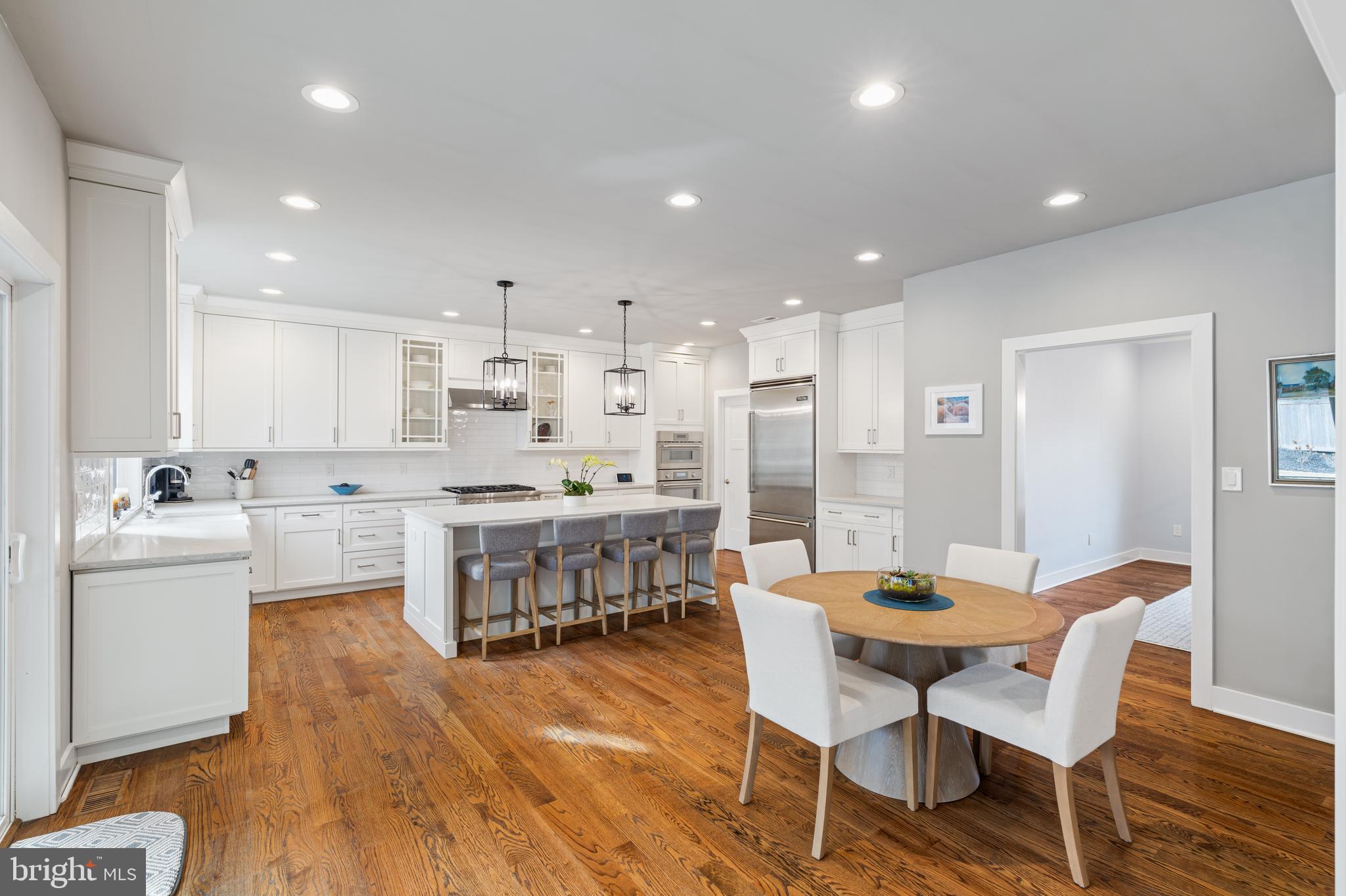 601 Spruce Lane Villanova, PA 19085 - Photo 10 of 27 a large kitchen with dining table chairs and wooden floor