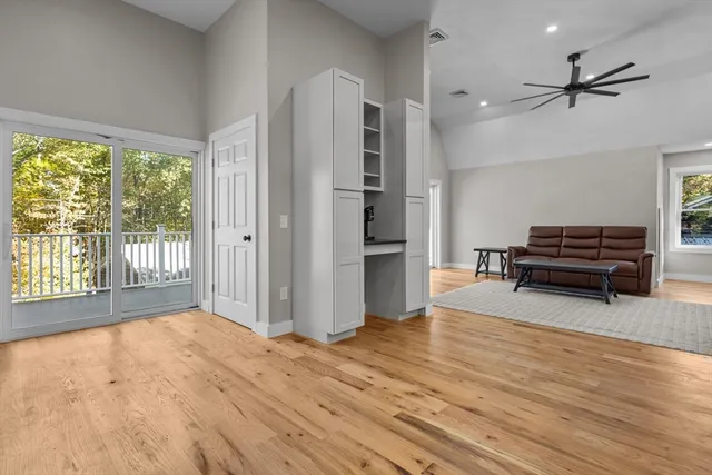 a living room with furniture and a wooden floor