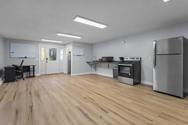 a view of a livingroom with wooden floor and a flat screen tv