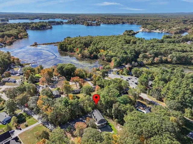 an aerial view of a houses with a lake view