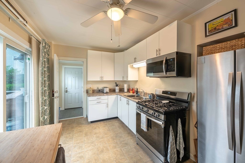 400 Anthony Street Fall River, MA 02721 - Photo 11 of 32 a kitchen with stainless steel appliances granite countertop a stove refrigerator sink and microwave