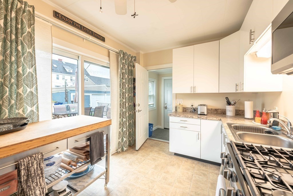 400 Anthony Street Fall River, MA 02721 - Photo 13 of 32 a kitchen with a stove a sink and a refrigerator