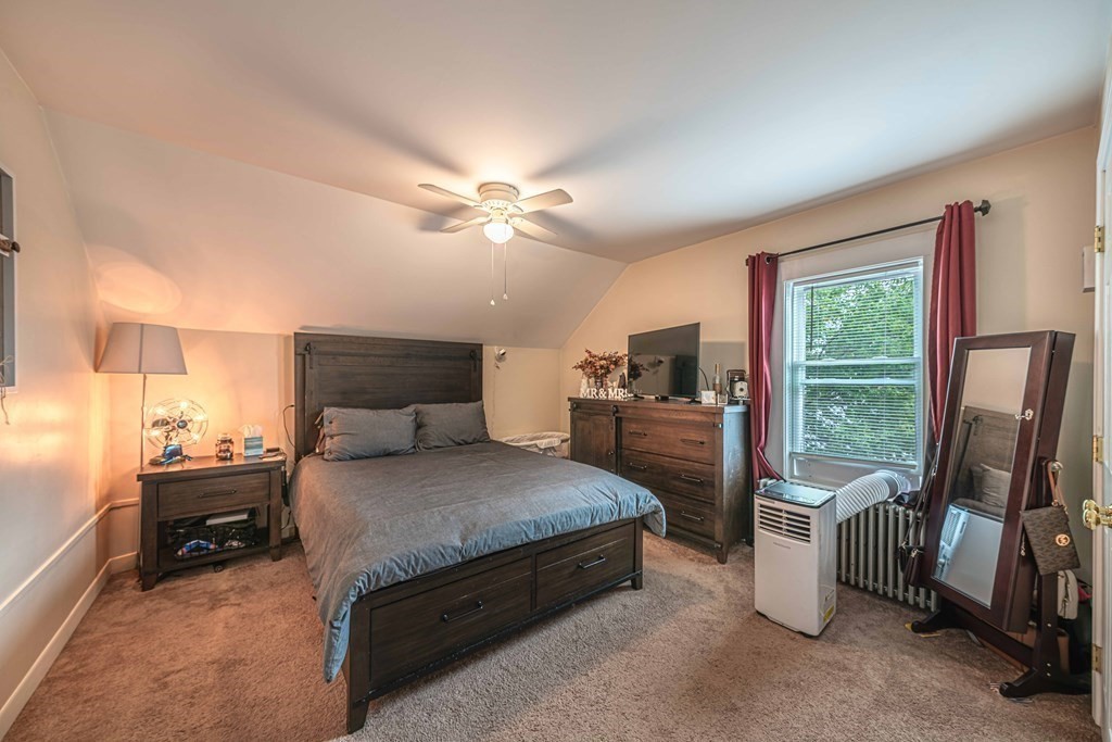 400 Anthony Street Fall River, MA 02721 - Photo 23 of 32 a spacious bedroom with a bed and a chandelier