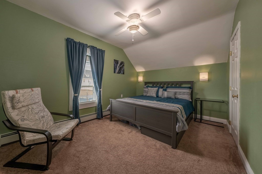 400 Anthony Street Fall River, MA 02721 - Photo 25 of 32 a bedroom with a bed and a chandelier