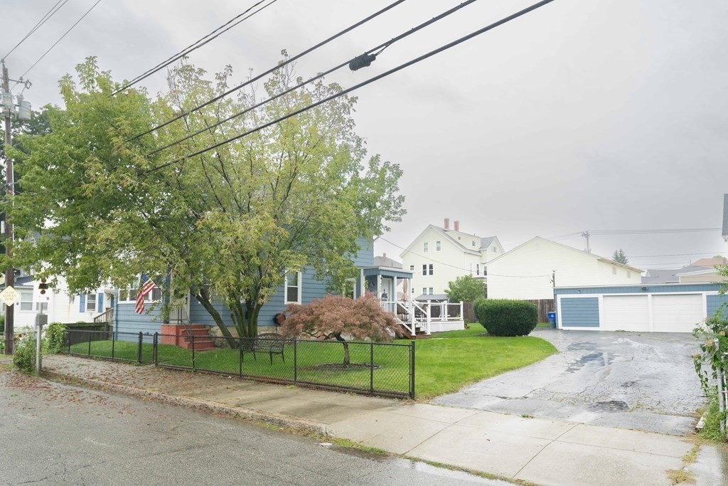 400 Anthony Street Fall River, MA 02721 - Photo 3 of 32 a front view of a house with a yard and garage