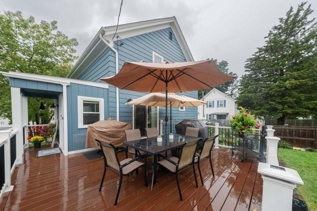 400 Anthony Street Fall River, MA 02721 - Photo 32 of 32 a view of a patio with table and chairs under an umbrella with wooden floor
