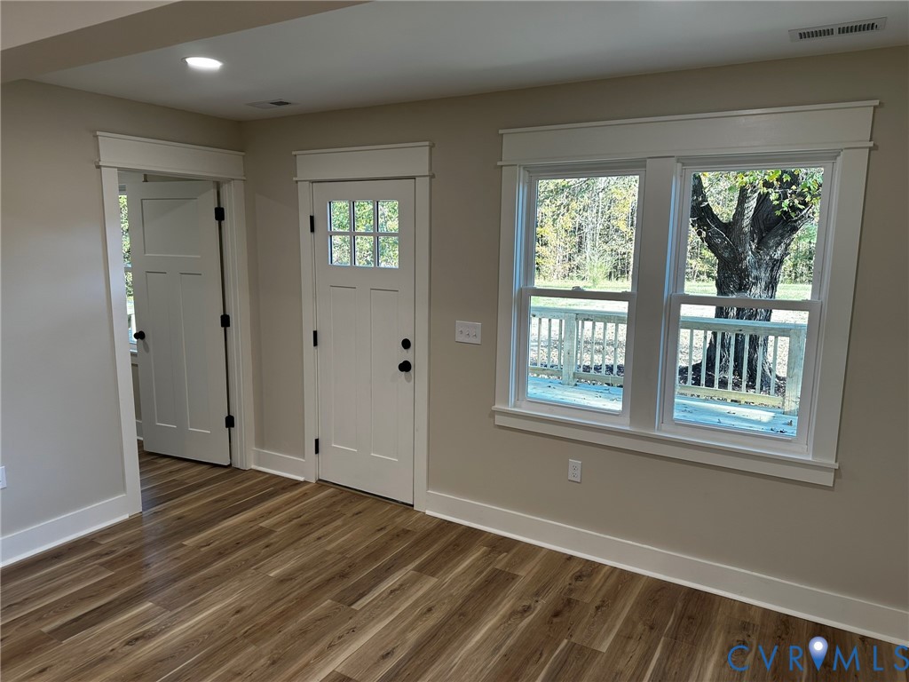 595 Liberty Road Alberta, VA 23821 - Photo 13 of 24 a view of an empty room with wooden floor and a window