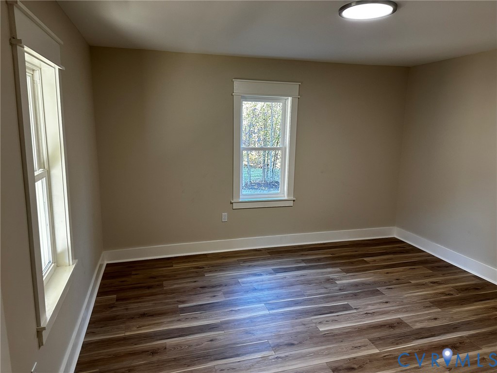 595 Liberty Road Alberta, VA 23821 - Photo 15 of 24 a view of an empty room with wooden floor and a window