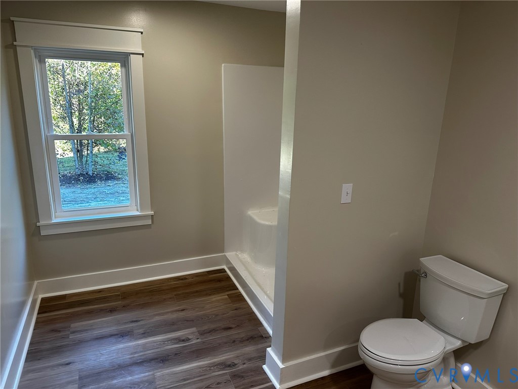 595 Liberty Road Alberta, VA 23821 - Photo 17 of 24 a bathroom with a toilet and a wooden floor