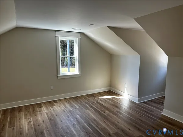 an empty room with wooden floor and closet
