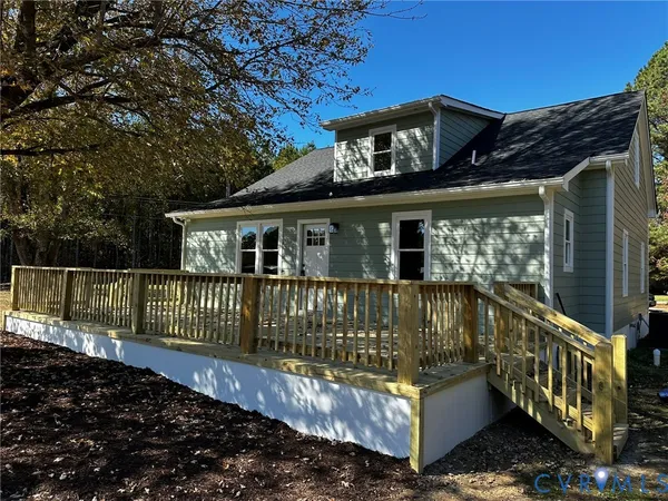 a view of a house with wooden fence