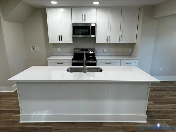 a kitchen with a stove and a microwave