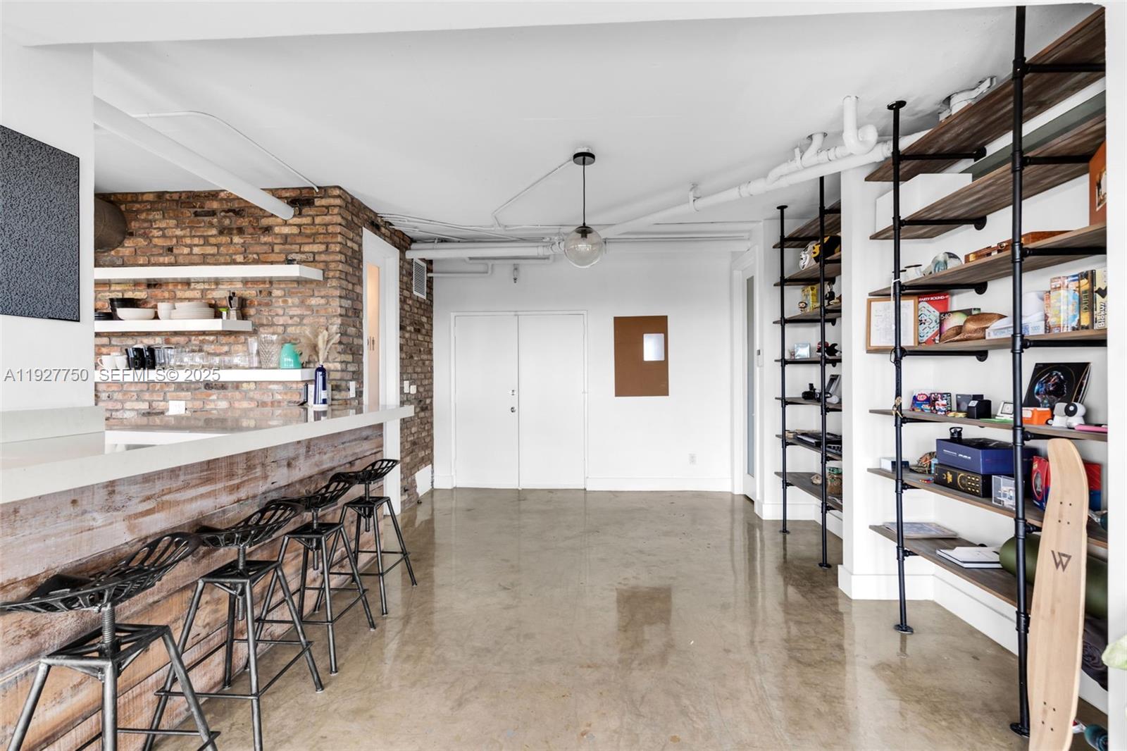 5701 Biscayne Boulevard, Unit PH9 Miami, FL 33137 - Photo 16 of 40 a dining room with furniture and a book shelf